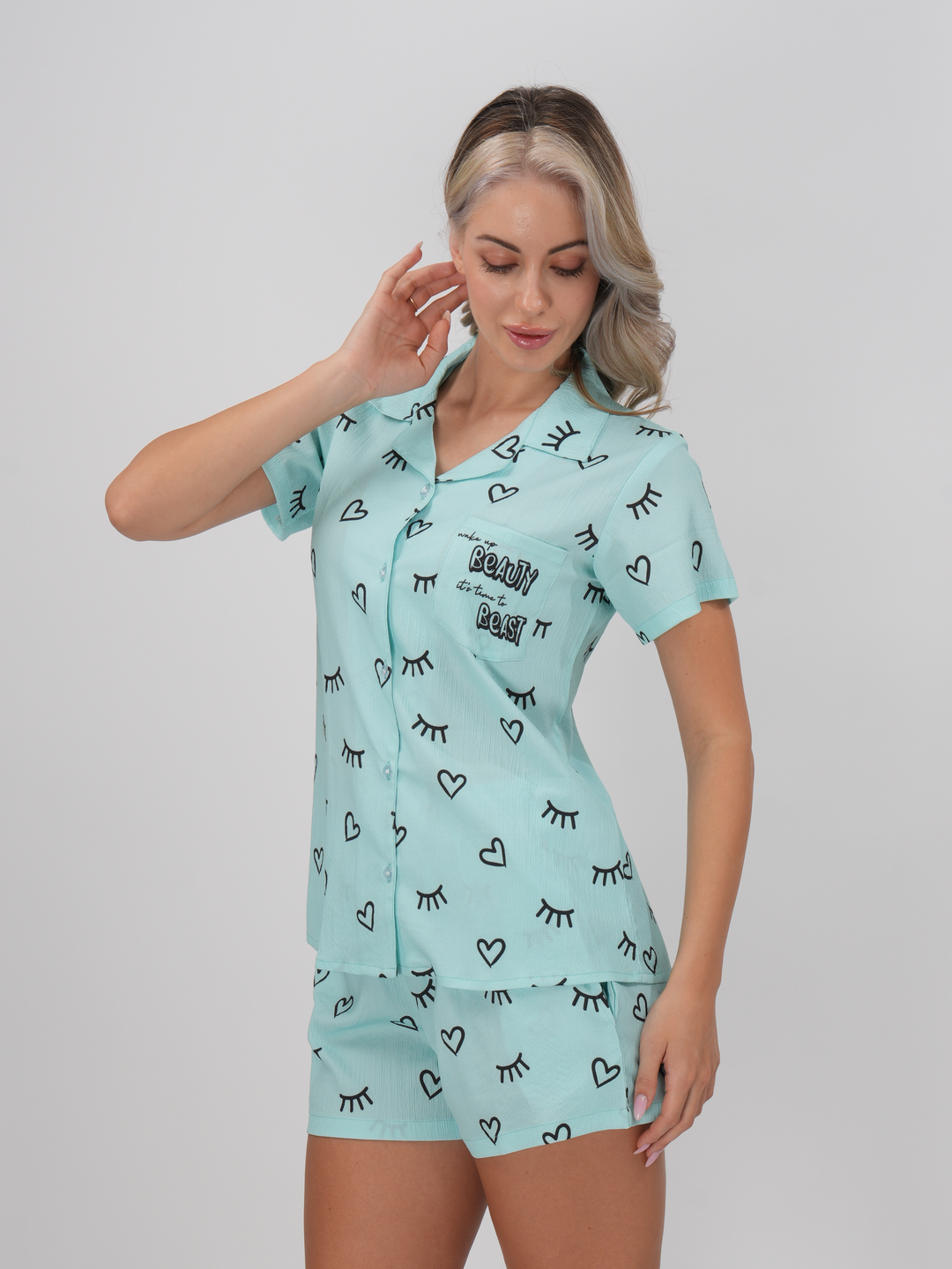 A woman standing wearing a blue short set with a classic collar and half-length sleeves - Blue Bliss Short Set