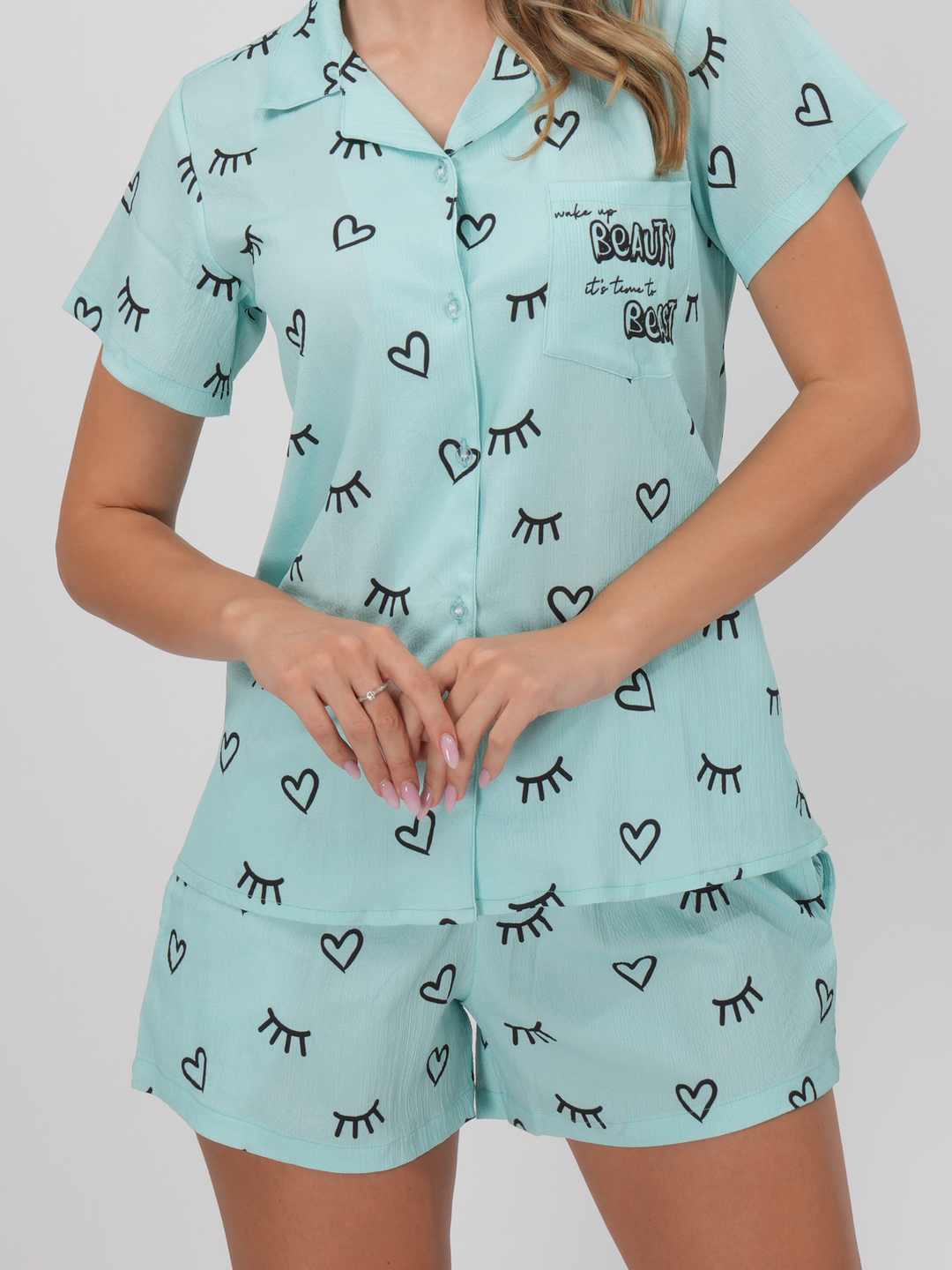 A woman standing wearing a blue short set with a classic collar and half-length sleeves - Blue Bliss Short Set