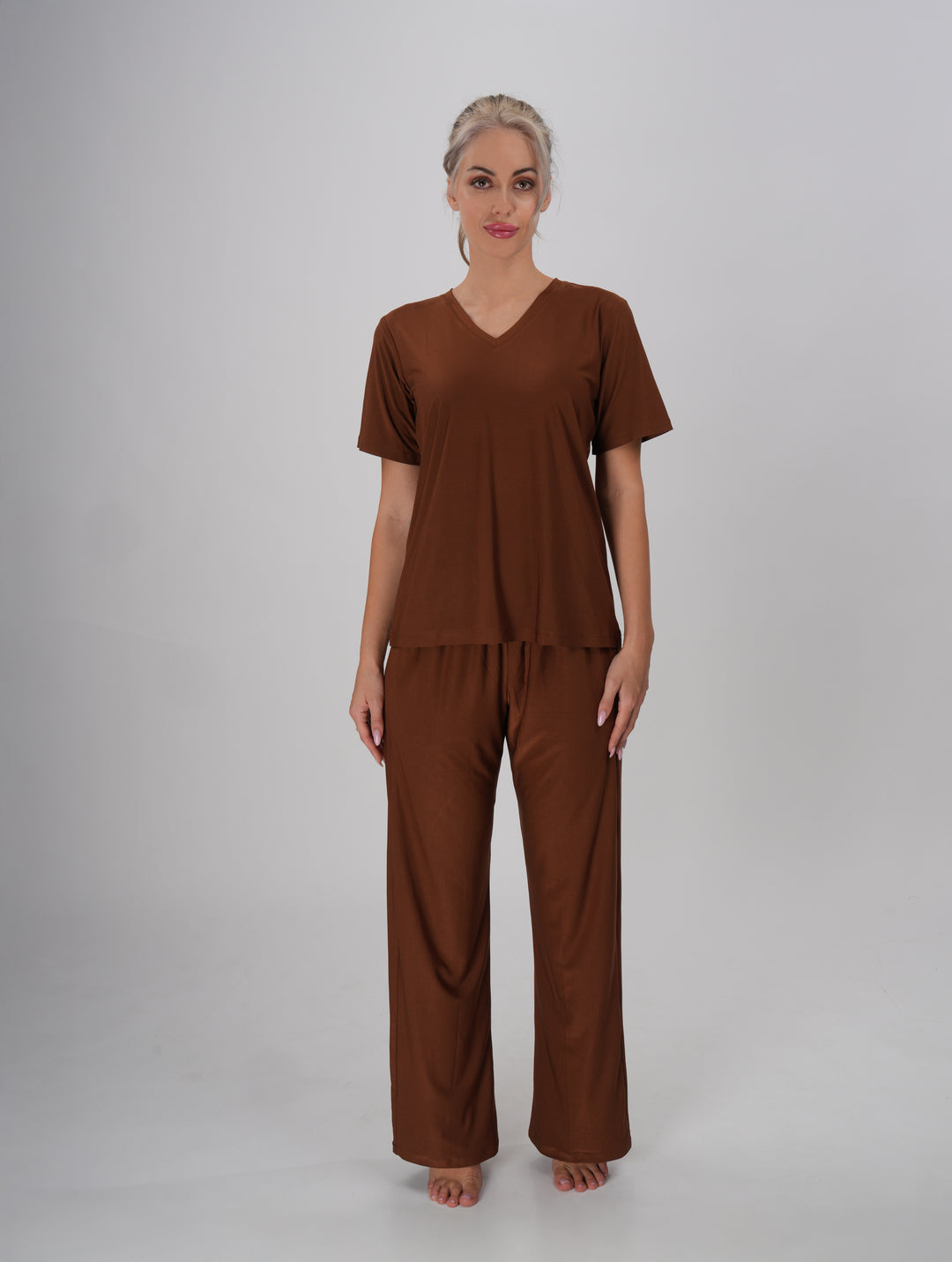 A Woman wearing a brown V-neck, short sleeve T-shirt and mid-rise pants with an elastic waistband - Coffee Crush PJ Set.