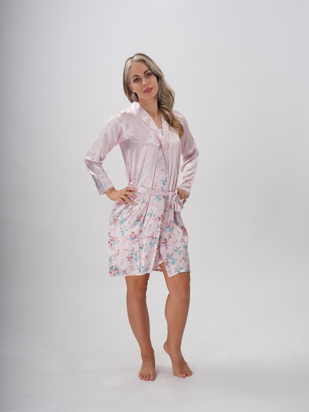 A woman wearing a pink floral robe with a round neckline and a sash belt - Mystical Bloom Robe