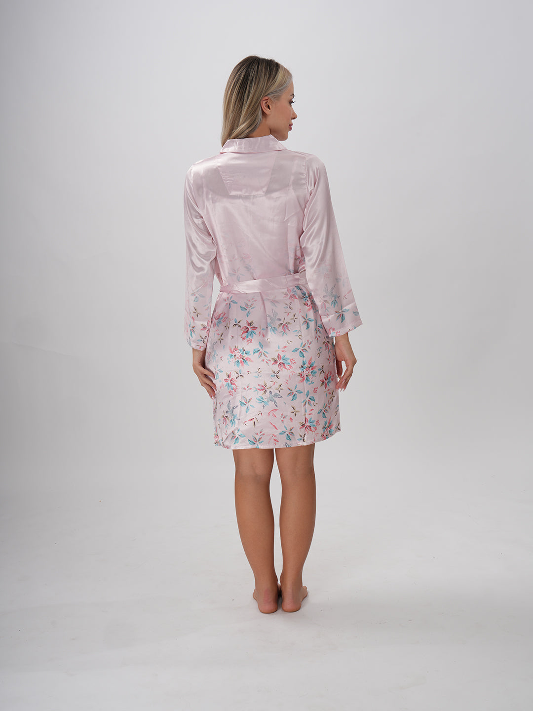 A woman wearing a pink floral robe with a round neckline and a sash belt - Mystical Bloom Robe
