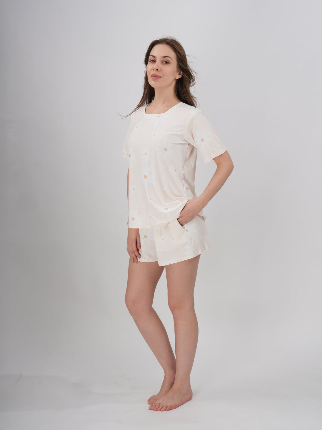 A female model wearing a cream colored short set with round neckline. - Prim Rose Short Set